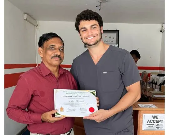 A graduate receiving his Preliminary Course in Ayurveda certificate