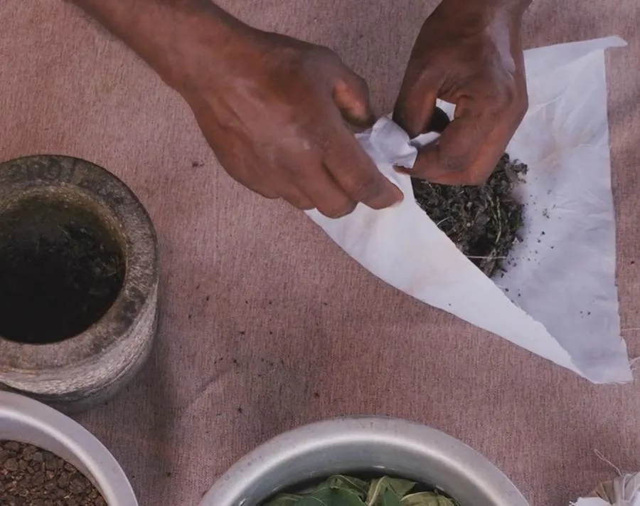 Preparing an herbal compress at Praanadha Ayurveda Wellness